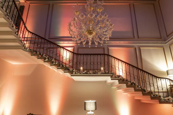 chanelier with red lights in background