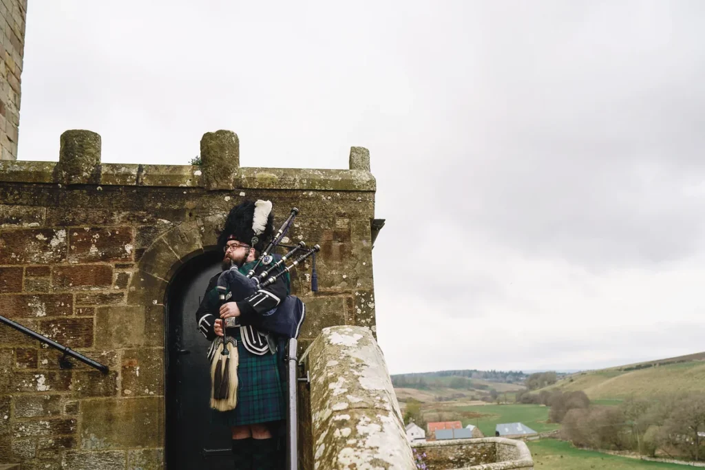 man playing bag pipes