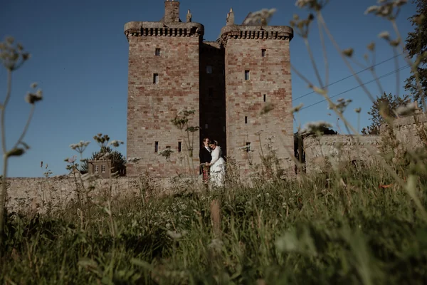 couple getting married outside borthwick castle